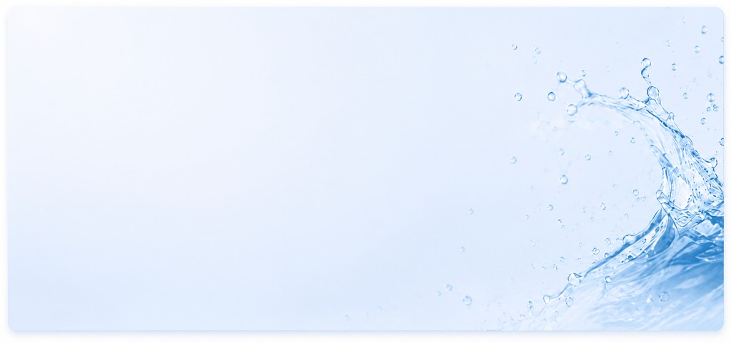 Bottled water pouring into a glass beside a JSM Water cooler